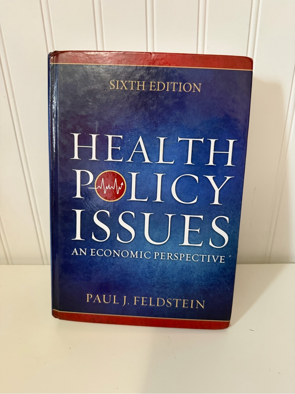 Health Policy Issues by Paul J. Feldstein - Blue and Red Hardcover Textbook